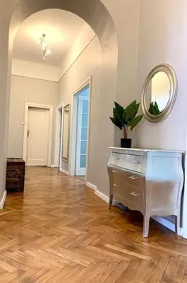 a living room with a dresser and a mirror at Floriańska Grand Apartment 2 in Kraków