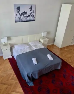 a bedroom with a bed with two pillows on it at Floriańska Grand Apartment 2 in Kraków