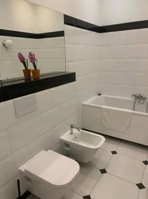 a bathroom with a toilet and a sink and a tub at Floriańska Grand Apartment 2 in Kraków