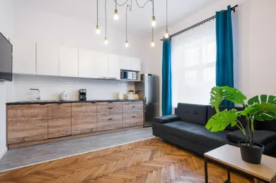 a living room with a couch and a kitchen at Fancy Apartments with Lift and A/C in Kraków