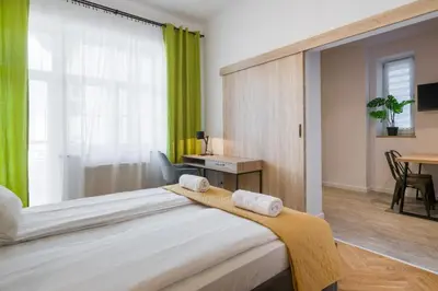 a bedroom with a large bed with towels on it at Fancy Apartments with Lift and A/C in Kraków