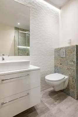 a white bathroom with a toilet and a sink at Fancy Apartments with Lift and A/C in Kraków