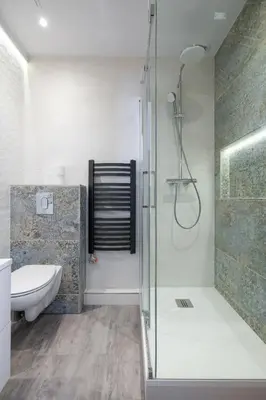 a bathroom with a shower and a toilet and a sink at Fancy Apartments with Lift and A/C in Kraków