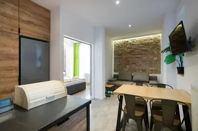 a living room with a table and chairs and a couch at Fancy Apartments with Lift and A/C in Kraków