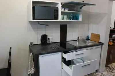 a small kitchen with a sink and a microwave at Apartament Leszczynowa 7 blisko Zatora in Spytkowice