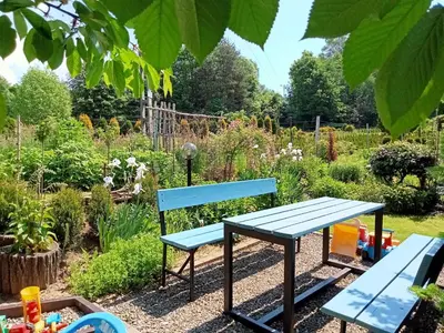 a blue bench and a table in a garden at Apartament Leszczynowa 7 blisko Zatora in Spytkowice