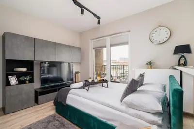 a bedroom with a large bed and a tv at Apartments Old Town Rakowicka by Noclegi Renters in Kraków
