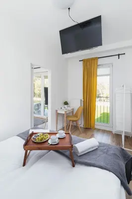 a living room with a table on a bed at Apartments Old Town Rakowicka by Noclegi Renters in Kraków