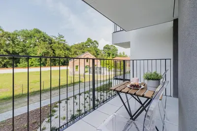 a balcony with a table and a view of a field at Apartments Old Town Rakowicka by Noclegi Renters in Kraków