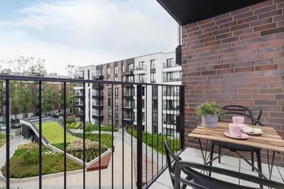 a garden with flowers in front of buildings at Apartments Old Town Rakowicka by Noclegi Renters in Kraków