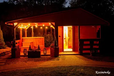 a small shed with lights on it at night at Kozinówka in Zawoja