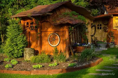 a small wooden house with a window in a yard at Kozinówka in Zawoja
