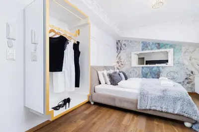 a bedroom with a bed and a dresser with a mirror at Modern Studio Węgierska Cracow by Noclegi Renters in Kraków