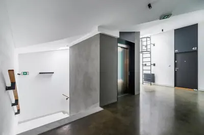 an empty room with white walls and concrete floors at Modern Studio Węgierska Cracow by Noclegi Renters in Kraków