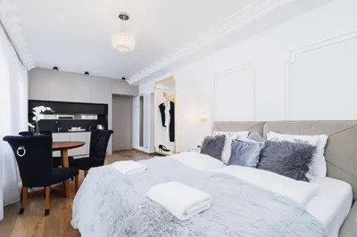 a bedroom with a bed and a table and chairs at Modern Studio Węgierska Cracow by Noclegi Renters in Kraków