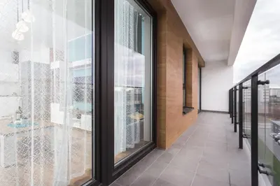 a hallway with glass doors and a view of the city at City of the Kings - Wolf Apartment in Kraków