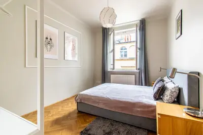a bedroom with a bed and a window at Brokilon House in Kraków