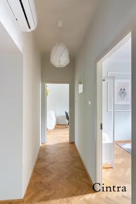 a hallway with a door leading to a living room at Brokilon House in Kraków