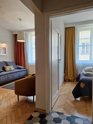 a living room with a door open to a bedroom at Brokilon House in Kraków
