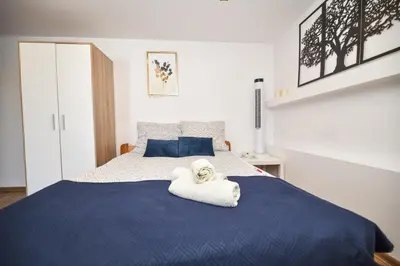 a bedroom with a blue bed with a towel on it at Noclegi u Majki in Zator