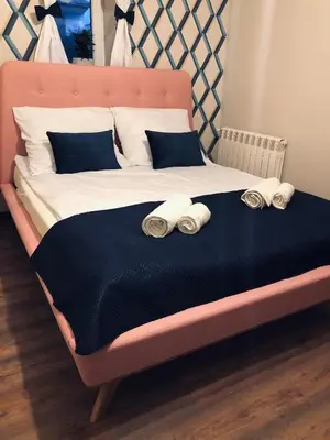 a bed with two pillows and two towels on it at Noclegi u Majki in Zator