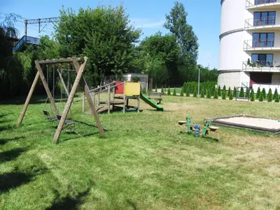 a yard with a playground with a swing set at Garden Corner in Kraków