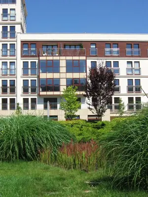 a tall building with a field of grass in front of it at Garden Corner in Kraków