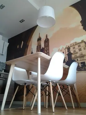 a table and chairs in a kitchen with a mural at Garden Corner in Kraków