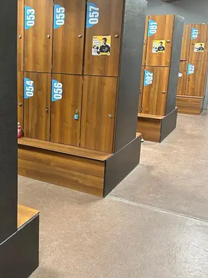 a row of lockers in a gym with stickers on them at Garden Corner in Kraków