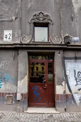 a door to a building with graffiti on it at Słowackiego Apartments in Kraków