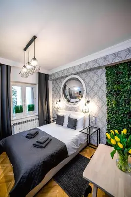 a bedroom with a large bed and a large mirror at Słowackiego Apartments in Kraków
