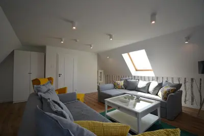 a living room with a couch and a table at Willa Wiesia Rabka Zdrój in Rabka