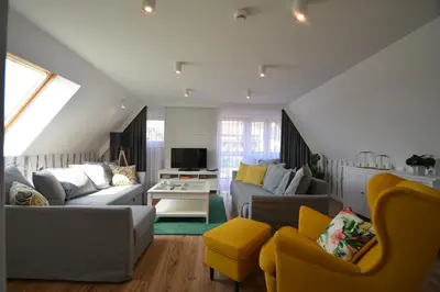 a living room with two couches and a tv at Willa Wiesia Rabka Zdrój in Rabka