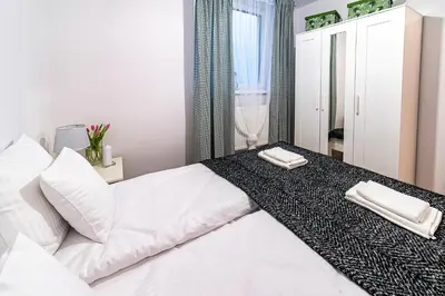 a bedroom with a white bed with two towels on it at Kopalnia Snów in Wieliczka