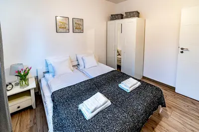 a bedroom with a bed with two towels on it at Kopalnia Snów in Wieliczka