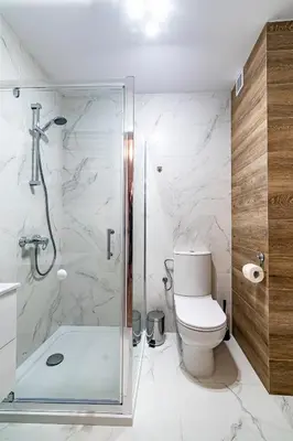 a bathroom with a glass shower and a toilet at Kopalnia Snów in Wieliczka