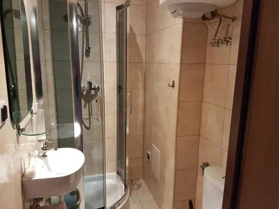 a bathroom with a shower and a sink and a toilet at Dream Hostel & Apartments in Kraków