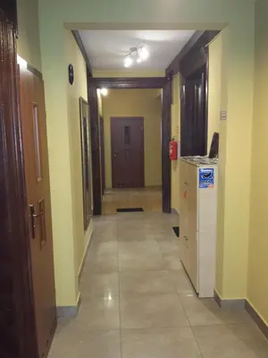 a hallway of a room with a door and a kitchen at Dream Hostel & Apartments in Kraków