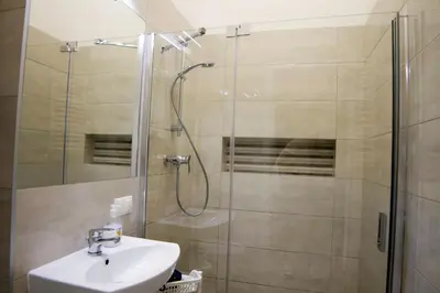 a bathroom with a shower and a sink at Dream Hostel & Apartments in Kraków