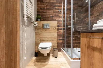 a bathroom with a toilet and a glass shower at Marvels Place with parking and AC in Kraków