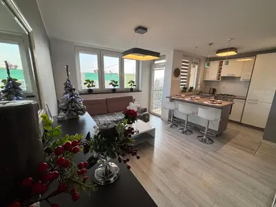a large living room with a kitchen and a living room at Ekskluzywny Apartament Joanna w centrum Bochni in Bochnia