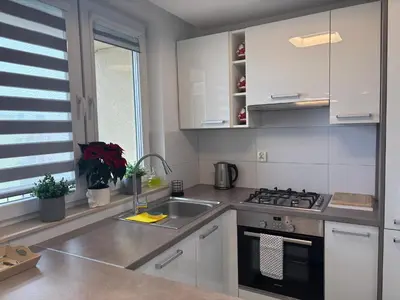 a kitchen with a sink and a stove at Ekskluzywny Apartament Joanna w centrum Bochni in Bochnia