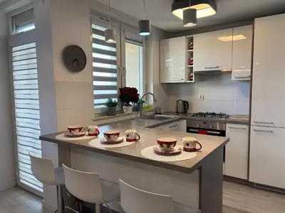 a kitchen with a counter with four cups on it at Ekskluzywny Apartament Joanna w centrum Bochni in Bochnia