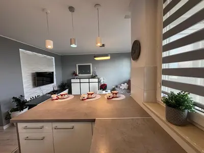 a kitchen with a large island with two plates on it at Ekskluzywny Apartament Joanna w centrum Bochni in Bochnia