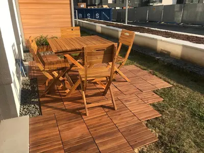 a wooden table and chairs sitting on a patio at Apartament with Garden BEZPŁATNY PARKING !!! in Kraków