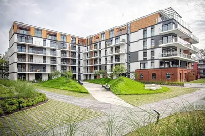 a large apartment building with a park in front of it at Apartament with Garden BEZPŁATNY PARKING !!! in Kraków