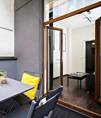 a dining room with a table and a mirror at Native Apartments Lubelska 14 in Kraków