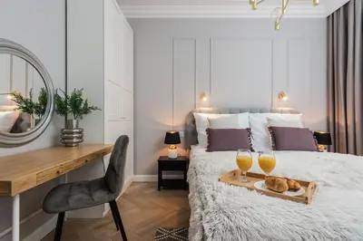 a bedroom with a bed with two glasses of wine at Wielopole17 Miro Apartment with AC in Kraków