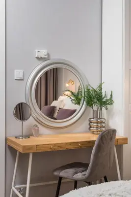 a round mirror on a desk with a chair at Wielopole17 Miro Apartment with AC in Kraków