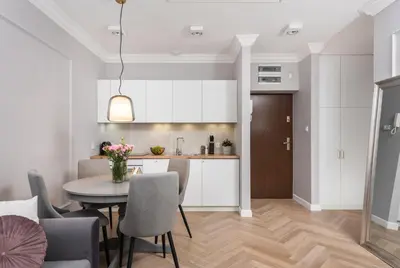 a kitchen and dining room with a table and chairs at Wielopole17 Miro Apartment with AC in Kraków